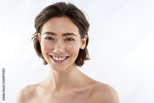 Front view of young happy brunette female