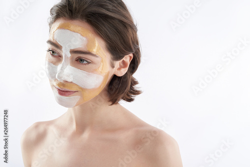 Top angle of tender pretty woman with face mask