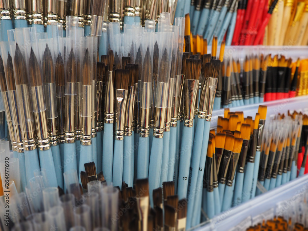 Blue and yellow brushes for painting in the art shop