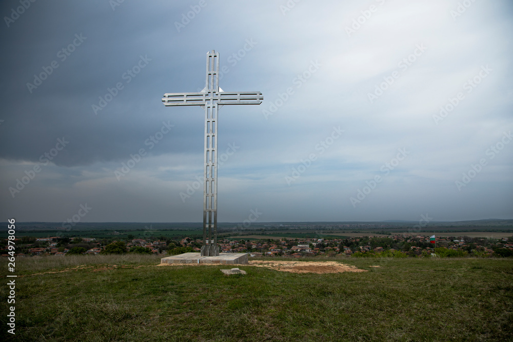 A Christian cross, a background of clouds and sunshine