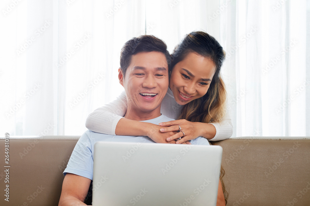 Cheerful couple shopping online Cheerful couple shopping online