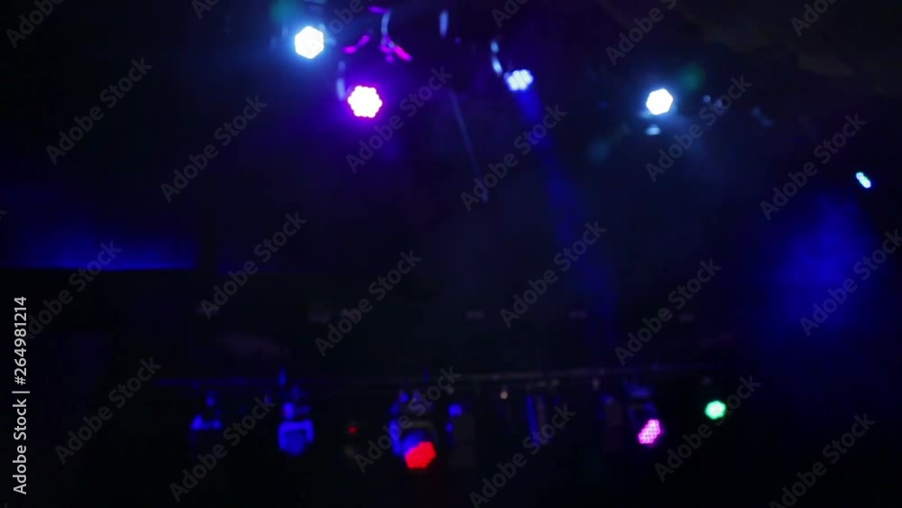 Professional lights shimmering in different colors over the stage in clouds of smoke are blurred Professional lights shimmering in different colors over the stage in clouds of smoke are blurred