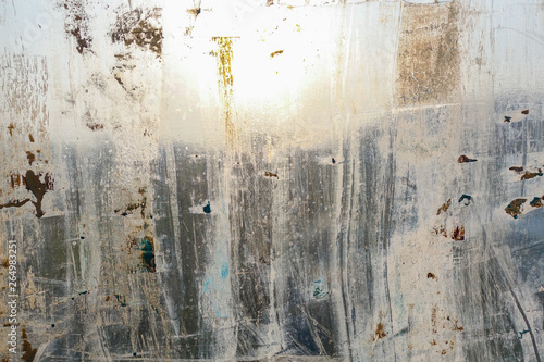 Abstract background. Window chaotically smeared with paint  illuminated by the sun.