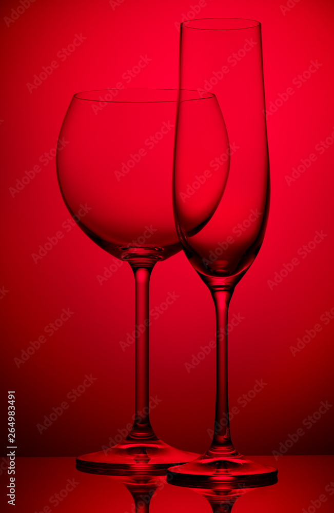 Two wineglasses on red