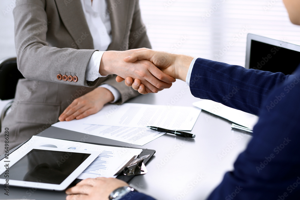 Business people shaking hands, finishing up a meeting. Papers signing, agreement and lawyer consulting concept Business people shaking hands, finishing up a meeting. Papers signing, agreement and lawyer consulting concept