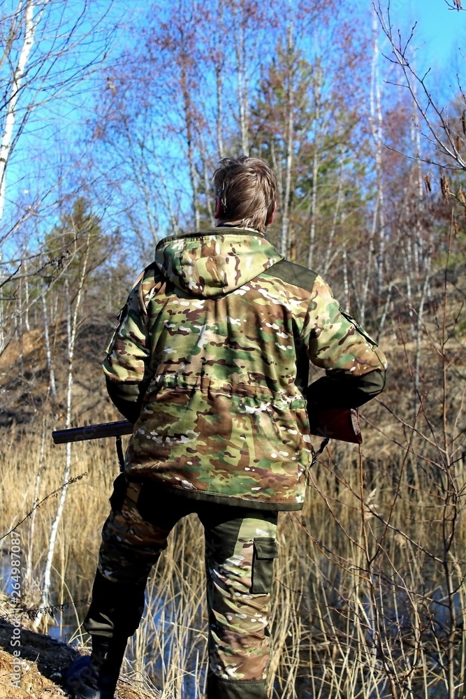 A novice hunter with a firearm on a spring hunting game.
