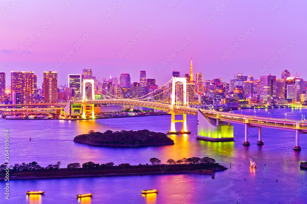 View of the Tokyo Bay and Rainbow Bridge at dusk in Tokyo.