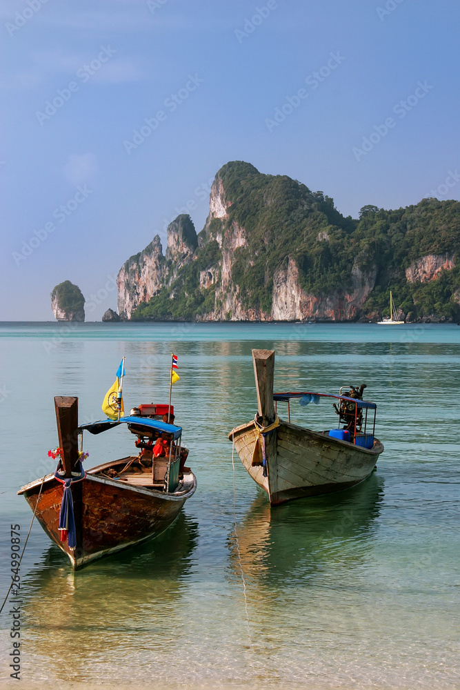 Longtail boats anchored at Ao Loh Dalum beach on Phi Phi Don Island, Krabi Province, Thailand