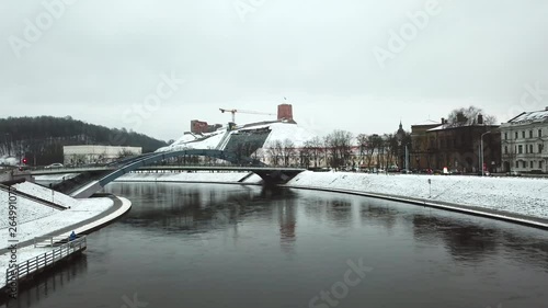 Aerial, drone shot, towards Mindaugas Bridge, above Neris river, on a foggy, cloudy, winter day, in Vilnius city, Lithuania photo