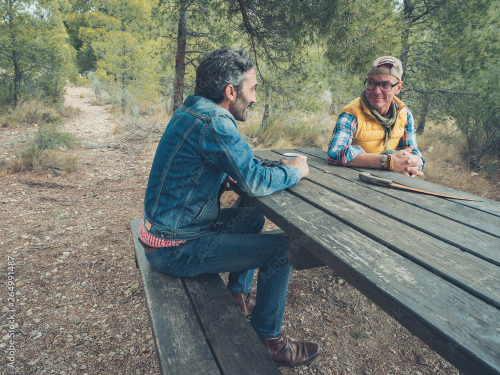 Fototapeta premium couple of men on a field trip sharing friendship