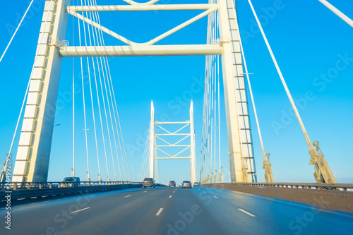 Travelling by car. Highway. Highway over the bridge. Cable bridge Cars move on the highway.