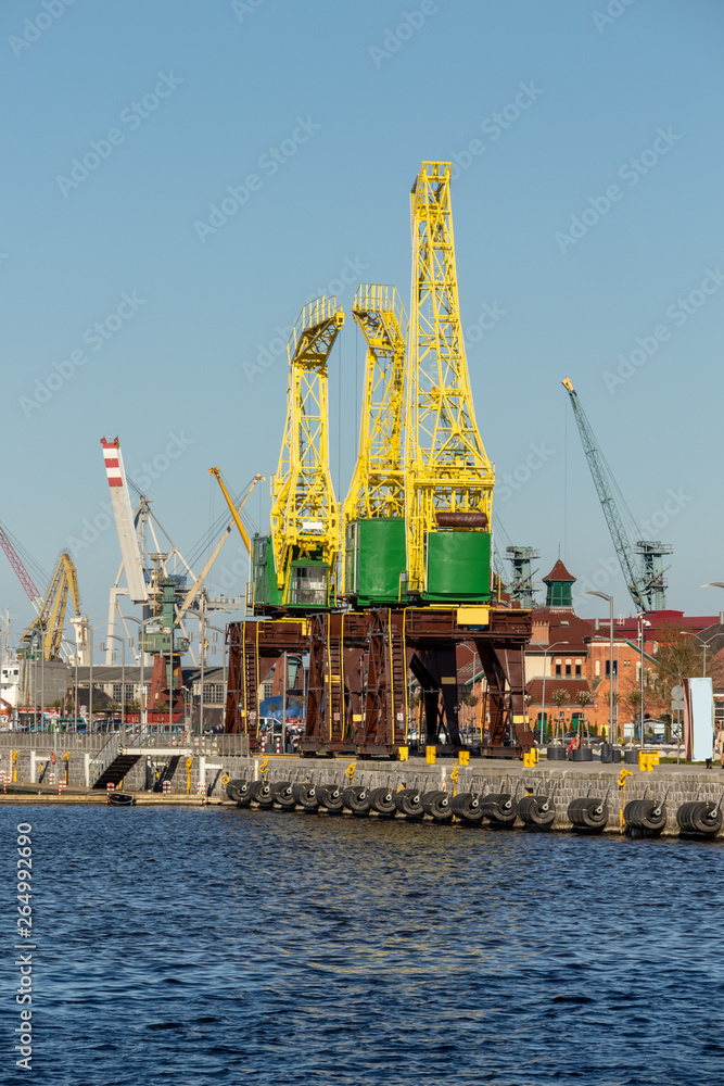 View of a harbor facility with ships, containers, cranes and equipment. Szczecin, Poland