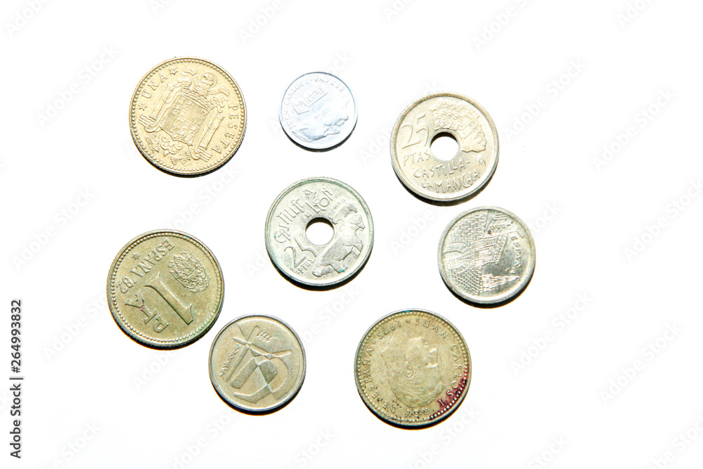 Old, invalid coins from Spain isolated on a white background. Old, invalid coins from Spain isolated on a white background.