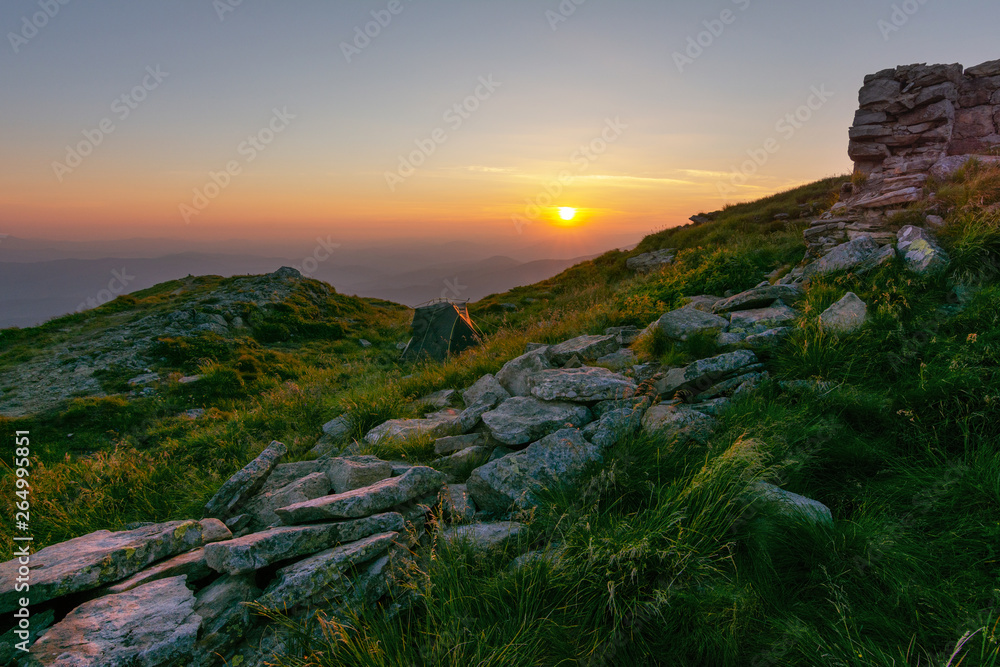 Fototapeta premium Warm summer season in the Ukrainian Carpathians with view of the observatory White elephant and tourist with a tent against the background of the mountains