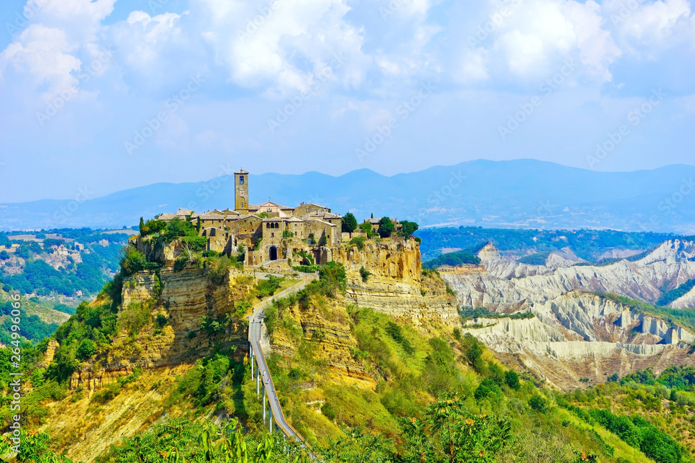 View of Civita village located on a hill and connected with Bagnoregio town by a bridge in central Italy.