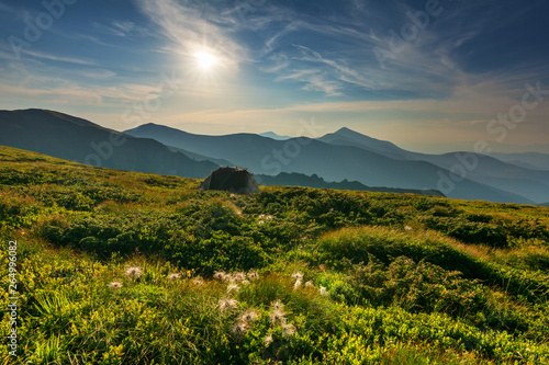 Warm summer season in the Ukrainian Carpathians with view of the observatory White elephant and tourist with a tent against the background of the mountains