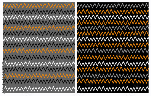 Set of 2 Abstract Seamless Irregular Vector Patterns with Hand Drawn Chevron Design. Funny White, Orange and Gray Zigzags Isolated on a Black Background. Cute Vivid Colors Infantile Style Waves. © Magdalena