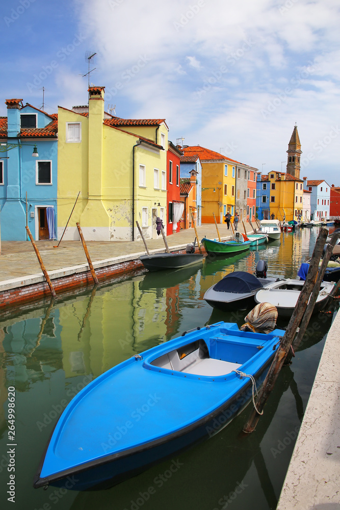 Boats anchored in canal in Burano, Venice, Italy