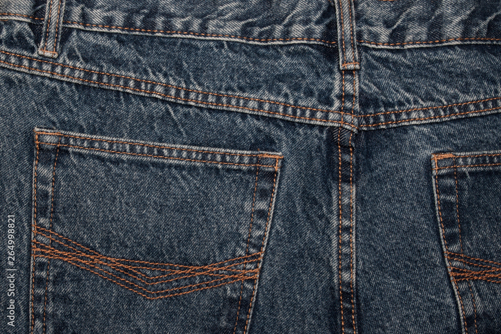 back of jeans. classic blue jeans back pockets. Classic jeans with five pockets close-up. Rough blue textured denim. trendy casual style back of jeans. classic blue jeans back pockets. Classic jeans with five pockets close-up. Rough blue textured denim. trendy casual style