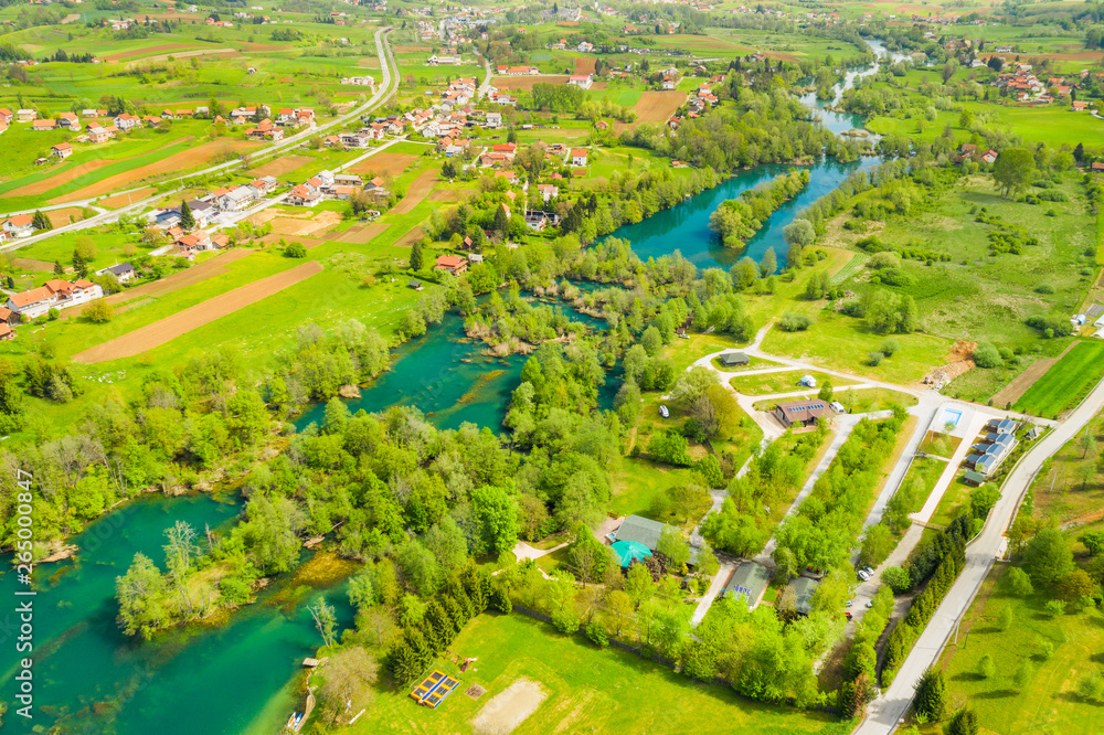Croatian countryside landscape, beautiful green Mreznica river from air, panoramic view of Belavici village and waterfalls in spring, popular tourist destination