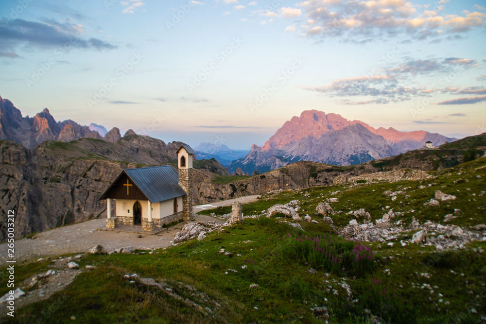 Beautiful panorama view of Cappella degli Alpini chapel in Tre Cime di lavaredo National Park. Idyllic sunrise landscape scene in Dolomites, Tirol Alps, Italy