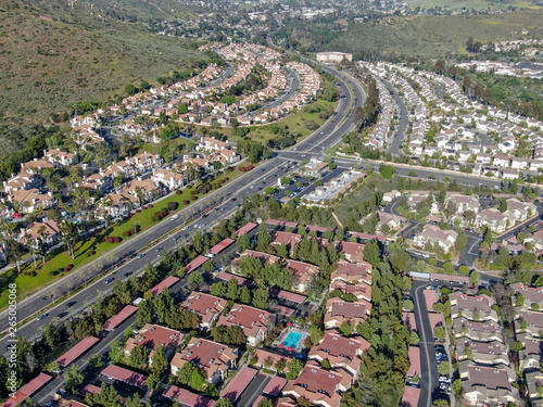 Aerial view suburban neighborhood with identical villas next to each other in the valley. San Diego, California, USA. Aerial view of residential modern subdivision luxury house with swimming pool.