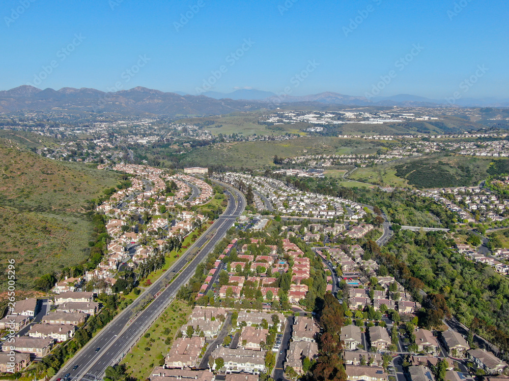 Aerial view suburban neighborhood with identical villas next to each other in the valley. San Diego, California, USA. Aerial view of residential modern subdivision luxury house with swimming pool.