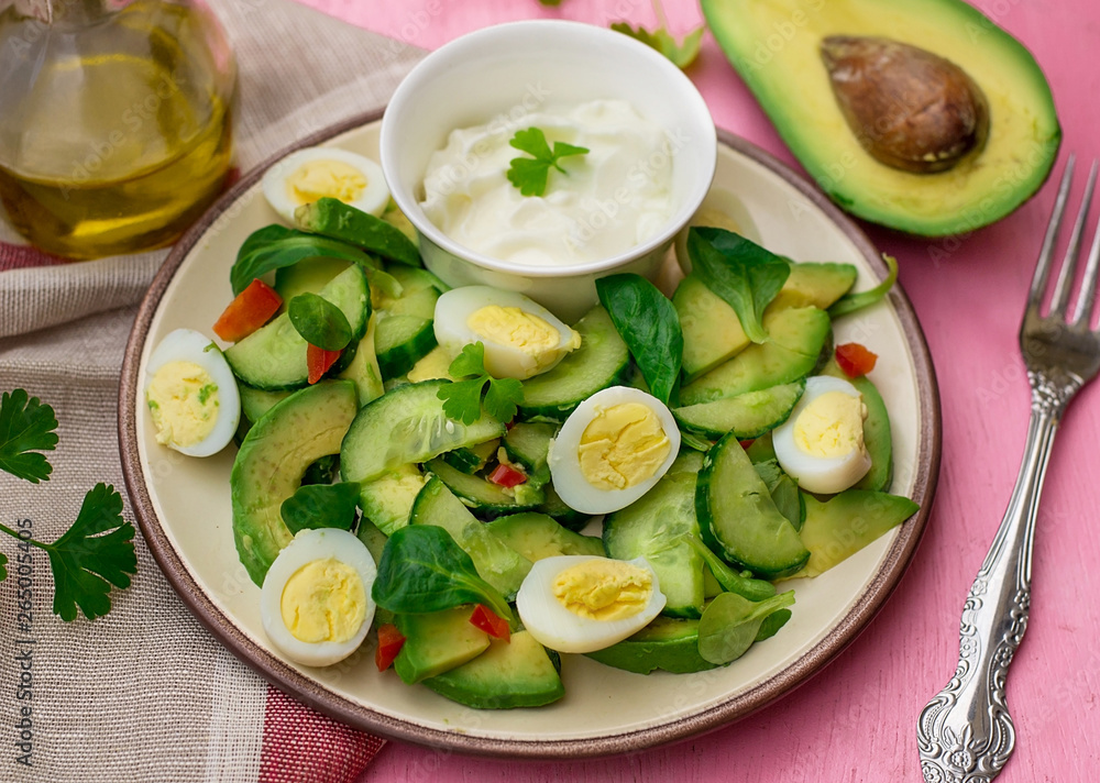 Fresh salad with avocado, cucumber, quail eggs and corn salad Fresh salad with avocado, cucumber, quail eggs and corn salad