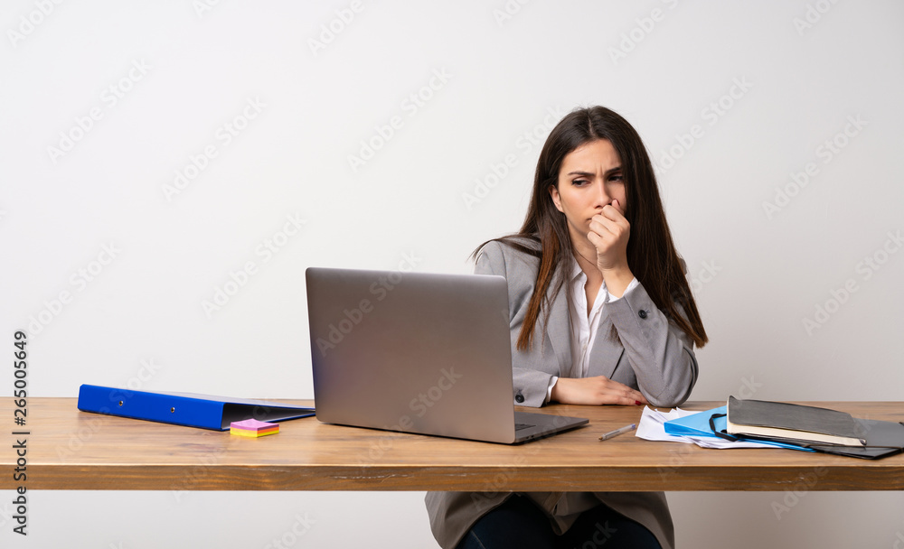 Business woman in a office having doubts Business woman in a office having doubts