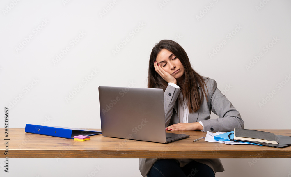 Business woman in a office making sleep gesture in dorable expression Business woman in a office making sleep gesture in dorable expression