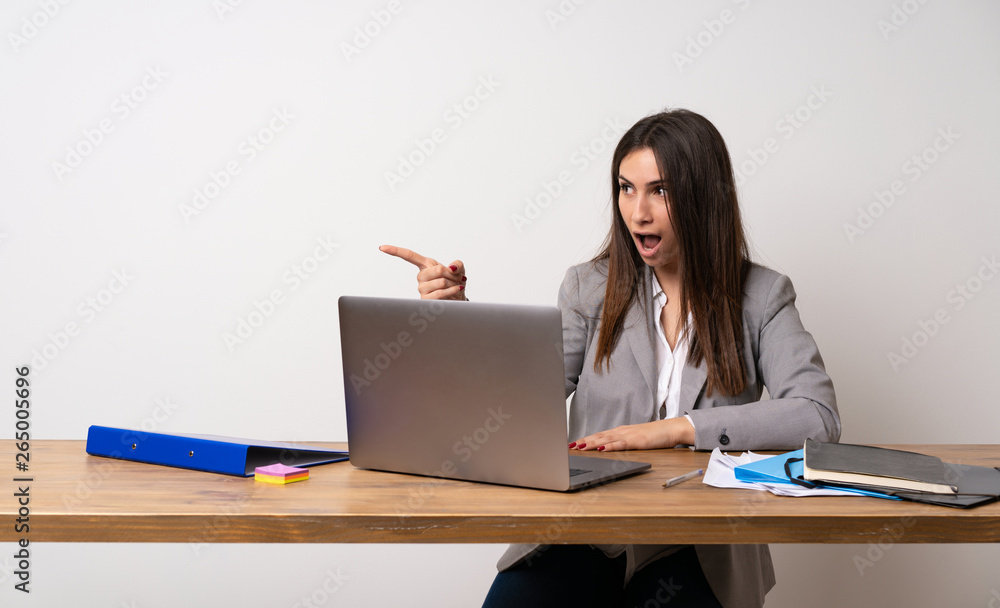 Business woman in a office pointing away Business woman in a office pointing away