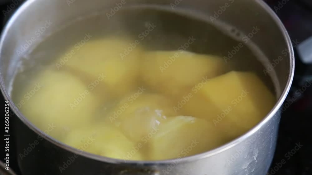 Cooking potatoes in a pan. Close up. Boiling water Cooking potatoes in a pan. Close up. Boiling water