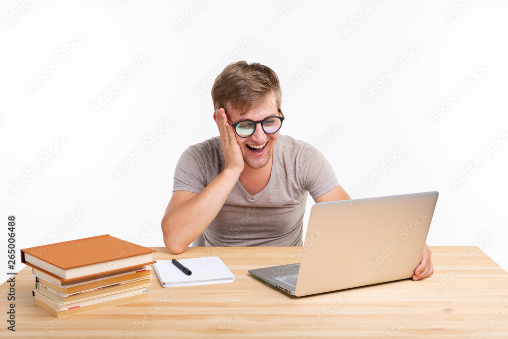 Study, education, people concept - man doing exercises in laptop, looking amazed Study, education, people concept - man doing exercises in laptop, looking amazed