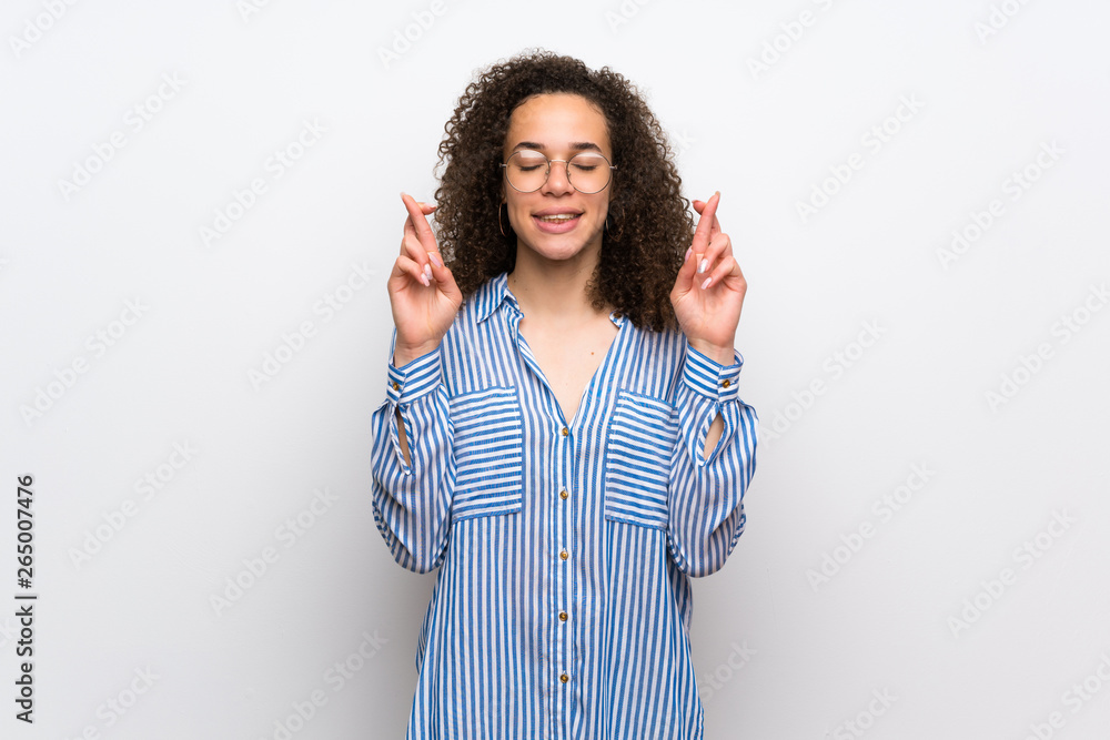 Dominican woman with striped shirt with fingers crossing and wishing the best