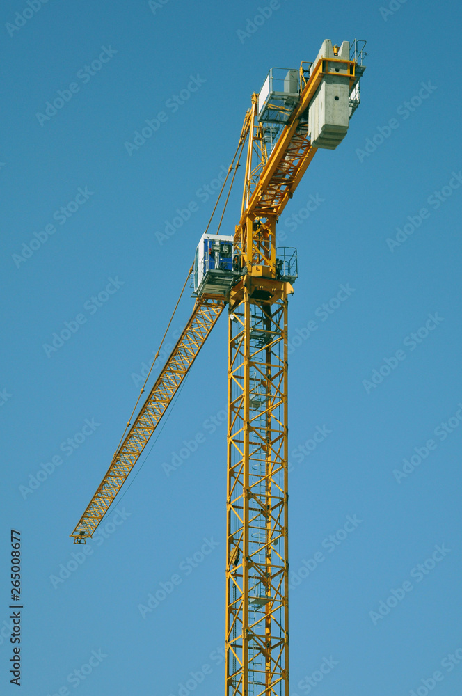 lifting tower crane against the blue sky. lifting tower crane against the blue sky.