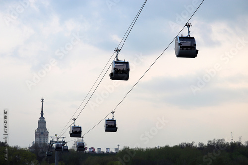 Moscow cable car in the Luzhniki. Funicular cabins against the  Moscow State University building and evening sky photo