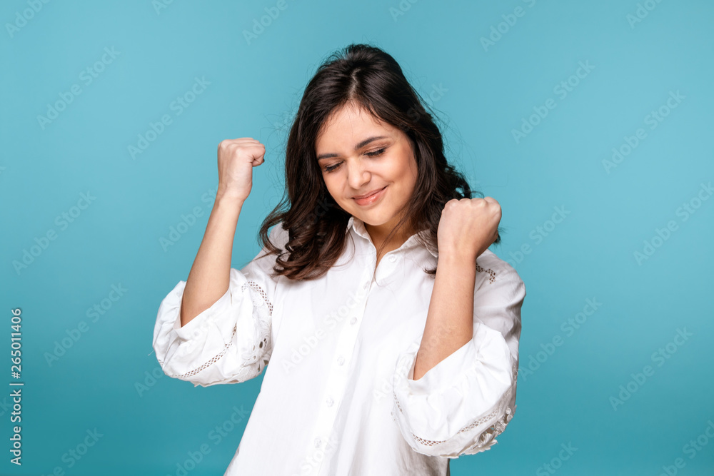 Happy woman on a blue background looking exited Happy woman on a blue background looking exited