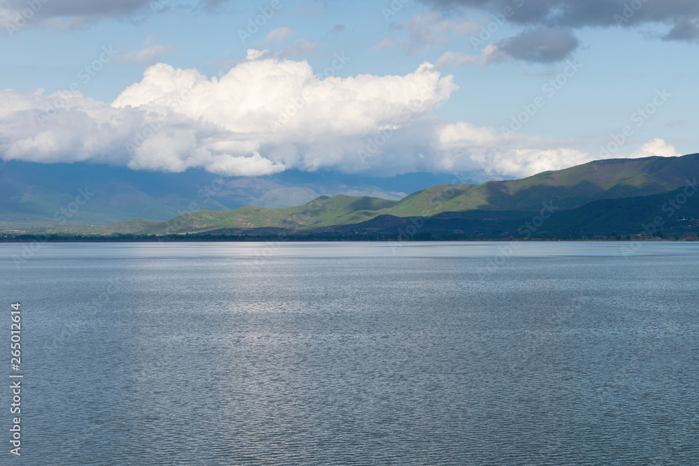 View of the lake and mountains on a sunny spring day.