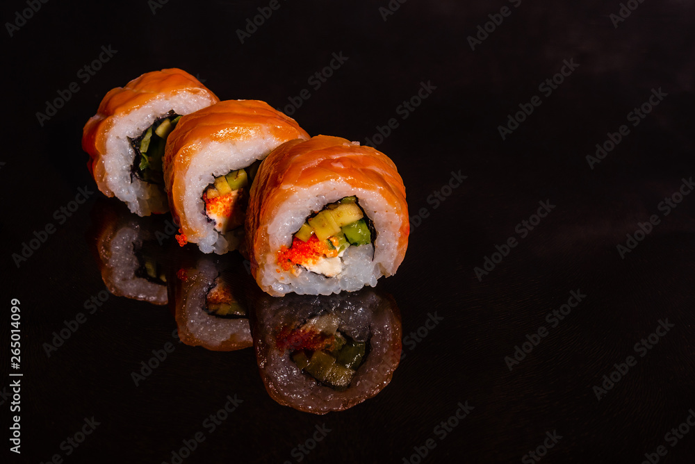Fresh and tasty sushi on dark background. It can be used as a background Fresh and tasty sushi on dark background. It can be used as a background