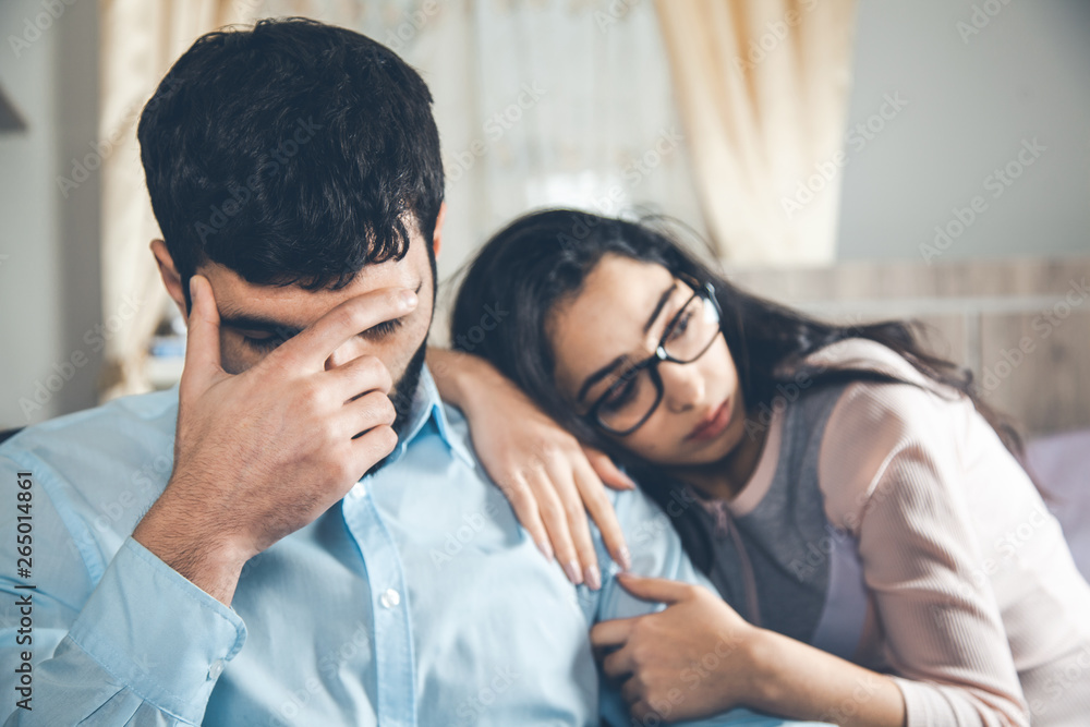 sad woman with man in home