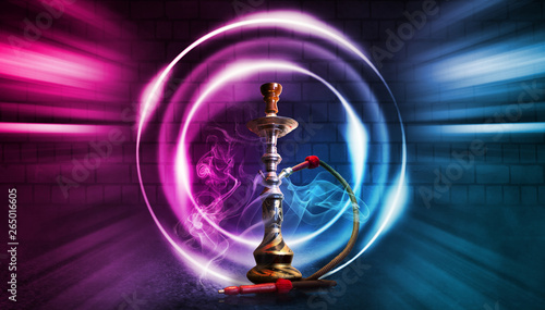 Hookah smoke on a dark abstract background. Background of empty scenes with multicolored neon lights  brick wall  reflection of night lights on wet asphalt