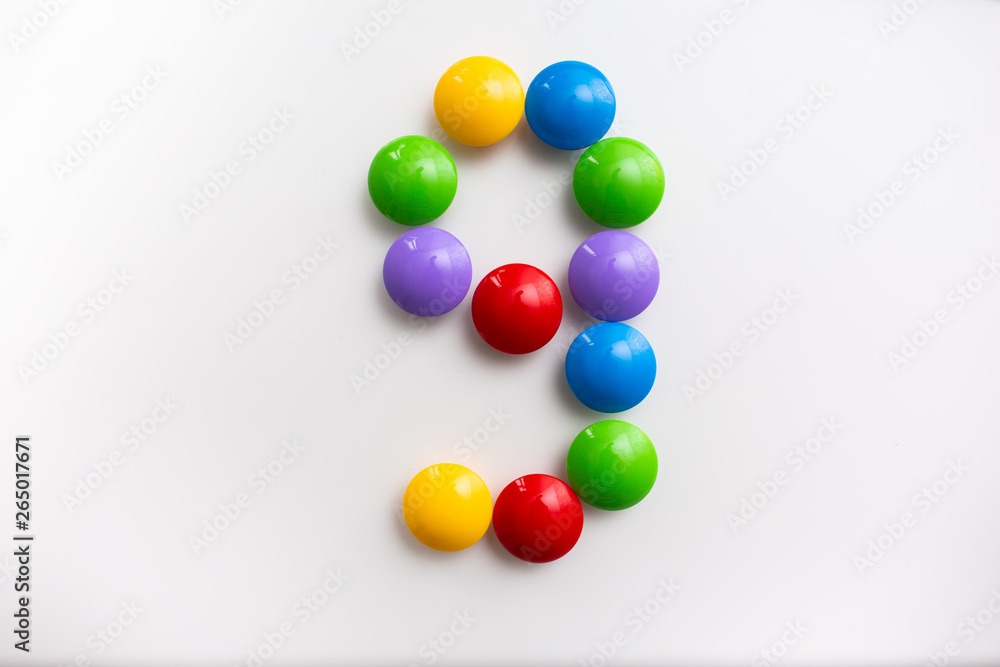 Digit 9 made from children's toys. Multicolored figures for games Digit 9 made from children's toys. Multicolored figures for games
