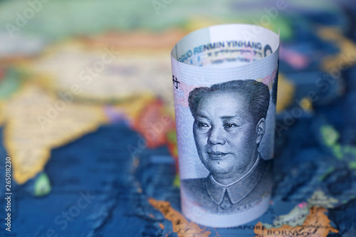 Yuan on the map of SouthEast Asia and Indonesia. Concept for chinese and asian economy, tourism, investment and trading photo