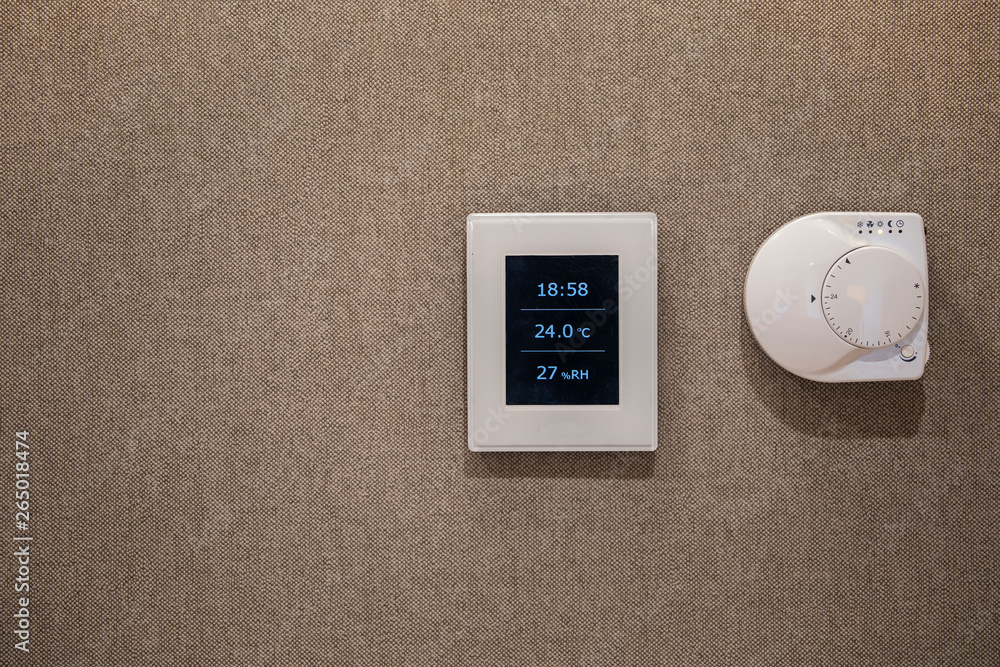 Electronic thermostat on the wall Electronic thermostat on the wall