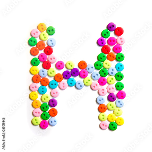 Letter H of the English alphabet made of multi-colored buttons