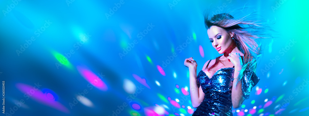 Fashion model sexy woman dancing in neon light. Disco dancer posing in UV colorful lights Fashion model sexy woman dancing in neon light. Disco dancer posing in UV colorful lights