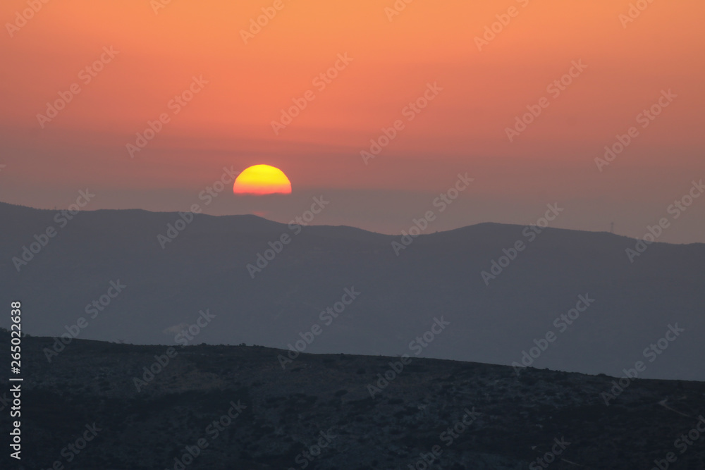Sunset on the mountain, sun setting behind the mountain. Sunset on the mountain, sun setting behind the mountain.