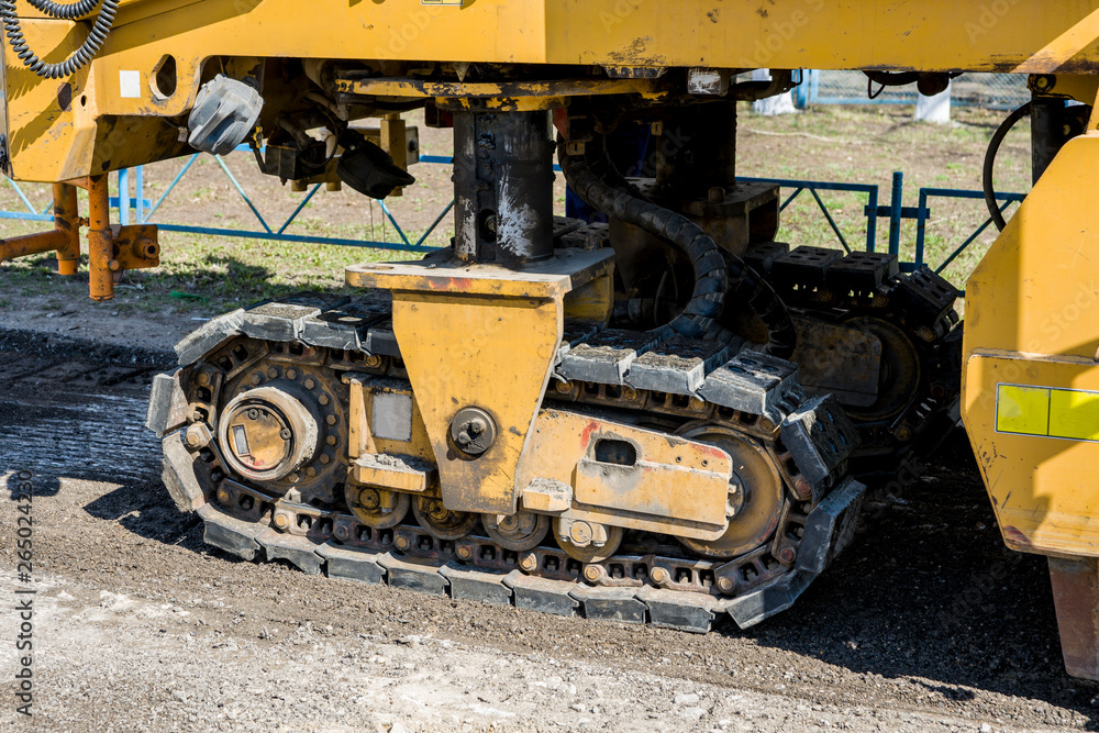 Road works. Dismantling of asphalt pavement. A fragment of a trimming unit-track. Road works. Dismantling of asphalt pavement. A fragment of a trimming unit-track.