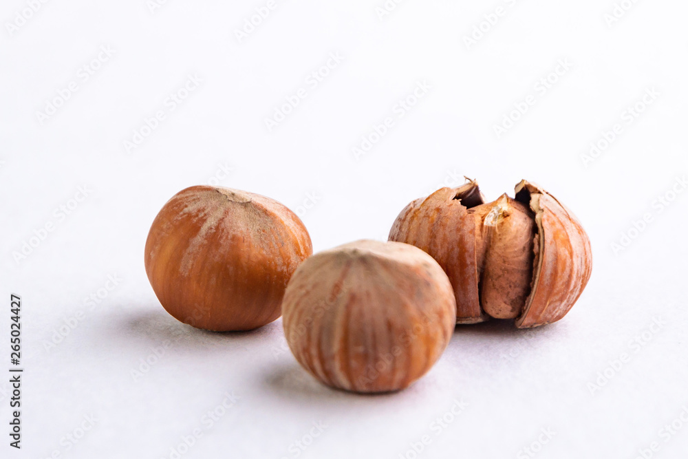 chopped hazelnuts, a pair of nuts lying side by side, on a white background, short focus chopped hazelnuts, a pair of nuts lying side by side, on a white background, short focus