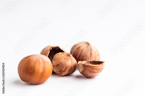 chopped hazelnuts, a pair of nuts lying side by side, on a white background, short focus